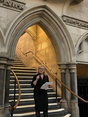 Lady Chief Justice Baroness Carr speaking on the steps inside the Royal Courts of Justice at the 75 years of women silks event