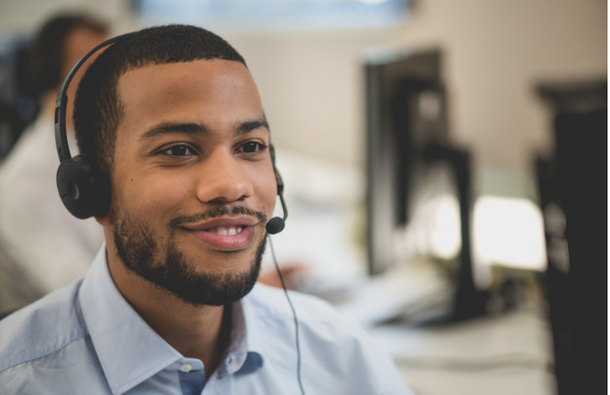 Man smiling while having a headset on.