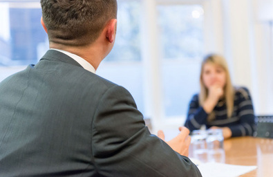 Two people sitting in meeting, in a discussion