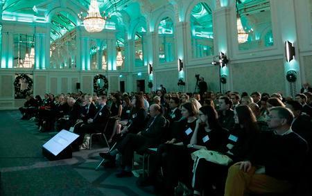 Photo of the main hall at the Grand Connaught Rooms, London - a crowd watching a presentation.