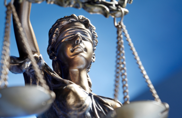 Close-up of a bronze Lady Justice statue.